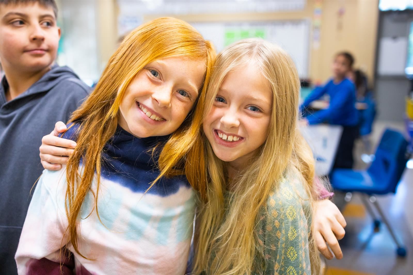 Two female students hugging each other